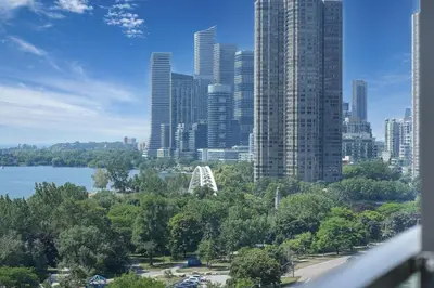 a view of a city skyline with tall buildings at Beachside 2 Bedroom Suite with CN Tower, lake View, and Parking! in Toronto