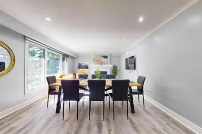 a dining room with a table and chairs at 10 Acre Farmhouse with Pool + 5 Bedrooms/3 Baths in East Gwillimbury