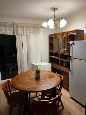 a kitchen with a wooden table and a refrigerator at House near University of Waterloo, Perimeter Institute, Wilfred Laurier University in Waterloo