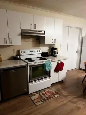 a kitchen with a stove and white cabinets at House near University of Waterloo, Perimeter Institute, Wilfred Laurier University in Waterloo