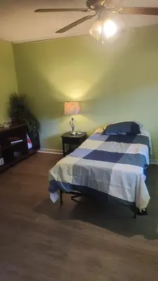 a bedroom with a bed with a blue and white comforter at House near University of Waterloo, Perimeter Institute, Wilfred Laurier University in Waterloo