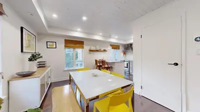 a kitchen with a white table and yellow chairs at Liberty Village-BMO Field-Roof Patio-Parking in Toronto