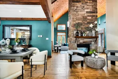 a living room with a fireplace and a table and chairs at Best Location Chalet Walk to Village-Ski in Ski out Extra Large Hottub in Blue Mountains