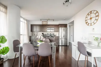 a kitchen and dining room with a table and chairs at Panoramic 2 Bedroom Condo with Terrace Fort York Downtown Toronto in Toronto