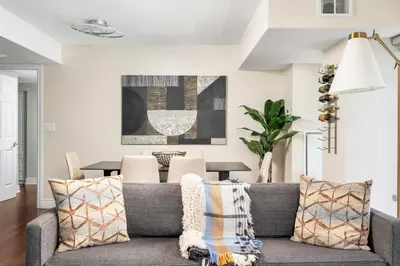 a living room with a gray couch with pillows at Centrally located 2 Bd 2 Bth + Parking in Toronto