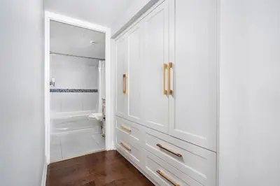 a bathroom with white cabinets and a shower at Centrally located 2 Bd 2 Bth + Parking in Toronto