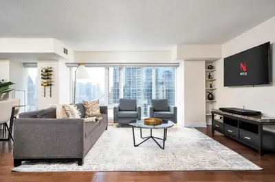 a living room with a couch and a tv at Centrally located 2 Bd 2 Bth + Parking in Toronto