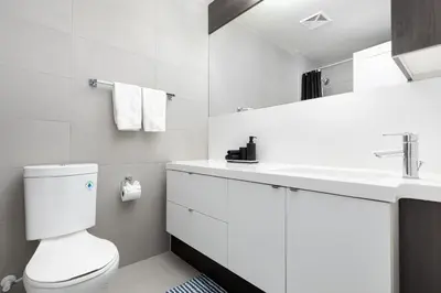 a white bathroom with a toilet and a sink at Apartament Downtown Toronto + Beautiful View in Toronto