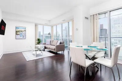 a living room with a table and chairs and a couch at Apartament Downtown Toronto + Beautiful View in Toronto