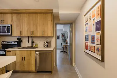 a kitchen with wooden cabinets and a dining room at Urban Oasis Steps to UofT Culture Patio in Toronto