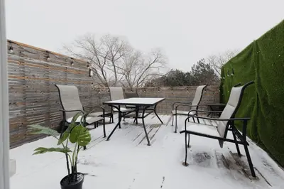 a patio with a table and chairs in the snow at Urban Oasis Steps to UofT Culture Patio in Toronto