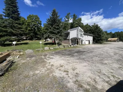 an empty lot in front of a white building at Stunning Lakeview Muskoka Pier 100 Resort in Port Carling