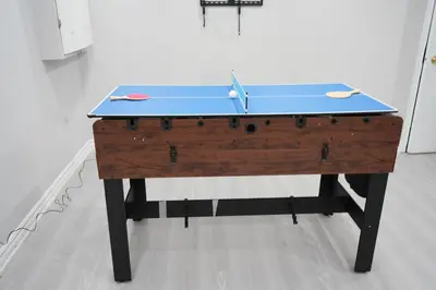 a blue ping pong table in a room at Large Family Favorite Spacious 6-Bedroom Home in Brampton