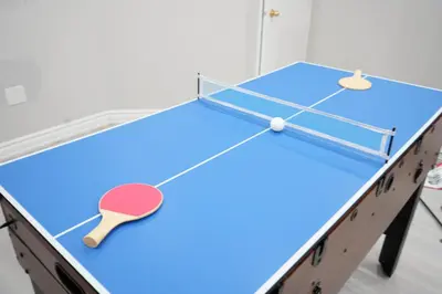 a ping pong table with a ping pong racket at Large Family Favorite Spacious 6-Bedroom Home in Brampton