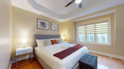 a bedroom with a large bed and a window at Modern & Spacious Midtown Toronto Family Home in Toronto