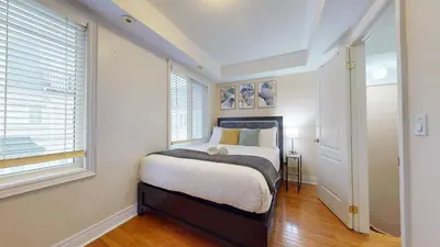 a bedroom with a bed and a window at Modern & Spacious Midtown Toronto Family Home in Toronto