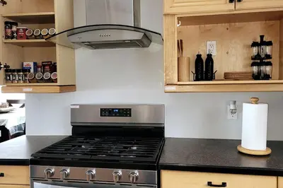 a kitchen with a stove top oven in a kitchen at Amazing Lakefront cottage on Paradise Lake in Haliburton