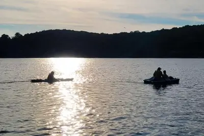 a group of people in canoes on a lake at Amazing Lakefront cottage on Paradise Lake in Haliburton