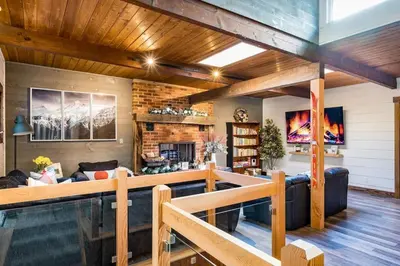 a living room with a couch and a fireplace at Cozy upgraded Chalet Hot Tubs Sauna Fireplace in Blue Mountains