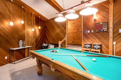 a pool table in a room with wooden walls at Cozy upgraded Chalet Hot Tubs Sauna Fireplace in Blue Mountains