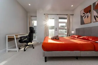 a bedroom with a bed and a desk and a chair at Elegant Five Bedroom Home Designed for Comfort and Space in Oakville