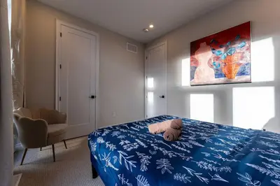 a bedroom with a teddy bear laying on a bed at Elegant Five Bedroom Home Designed for Comfort and Space in Oakville