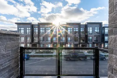 a building with the sun shining through a glass door at Elegant Five Bedroom Home Designed for Comfort and Space in Oakville