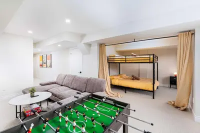 a living room with a pool table and a bed at Elegant Five Bedroom Home Designed for Comfort and Space in Oakville