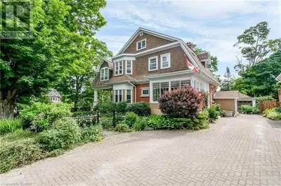 a house with a brick driveway in front of it at Warm, Stylish Edwardian Escape in Downtown Meaford in Meaford