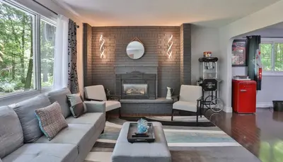 a living room with a couch and a fireplace at Cozy Georgian Bay Cottage Firepit, Beach, 4-Season in Tiny