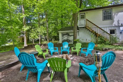 a group of chairs sitting around a fire pit at Cozy Georgian Bay Cottage Firepit, Beach, 4-Season in Tiny