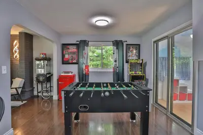 a room with a foosball table in the middle at Cozy Georgian Bay Cottage Firepit, Beach, 4-Season in Tiny