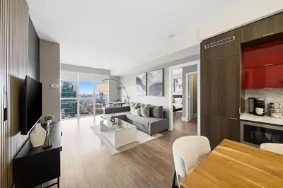 a kitchen and living room with a couch and a table at Modern City Condo with Parking Walk to CN Tower in Toronto
