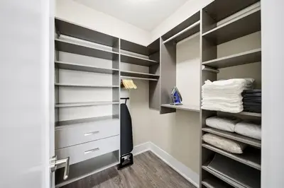 a walk in closet with black and white shelves at Modern City Condo with Parking Walk to CN Tower in Toronto