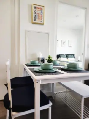 a white table with green dishes on top of it at Toronto Lakeview by TMU & UofT with Pool, Gym & Parking in Toronto