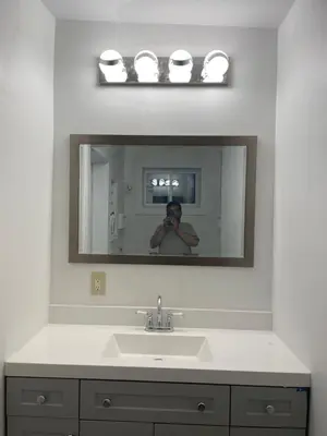 a man taking a picture of a bathroom mirror at Luxury room at southern Guelph in Guelph