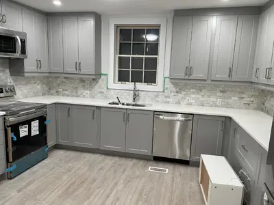 a kitchen with gray cabinets and a sink at Luxury room at southern Guelph in Guelph