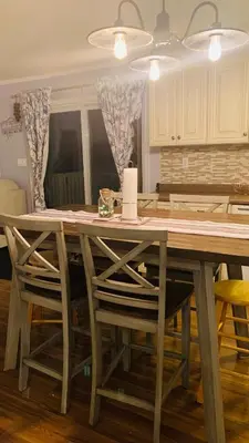 a kitchen with a wooden table and chairs at Rice Lake Retreat 2 Bed Home 16 Ft Swim spa Sauna in Bailieboro