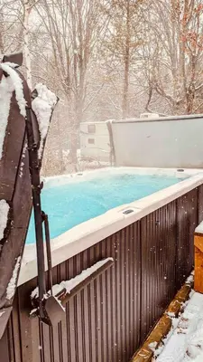 a swimming pool covered in snow in a yard at Rice Lake Retreat 2 Bed Home 16 Ft Swim spa Sauna in Bailieboro