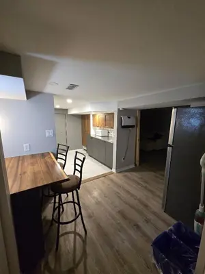 a living room and kitchen with a table and chairs at Cozy East Hill 2026 in Belleville