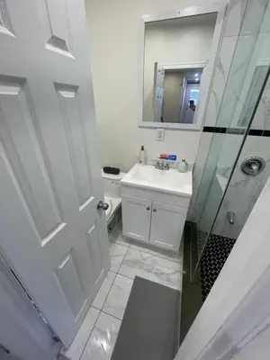 a white bathroom with a sink and a shower at DOWNTOWN-BMO Field Stay-Next to Transit-Restaurants-Union Station in Toronto