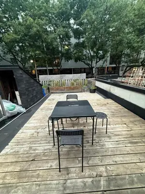 a table and two chairs sitting on a wooden deck at DOWNTOWN-BMO Field Stay-Next to Transit-Restaurants-Union Station in Toronto