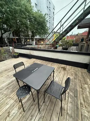 a table and two chairs on a wooden deck at DOWNTOWN-BMO Field Stay-Next to Transit-Restaurants-Union Station in Toronto