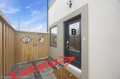 a room with a black door and a red arrow at Charming Streetsville 2 Bedroom Suite with Parking and Laundry in Mississauga