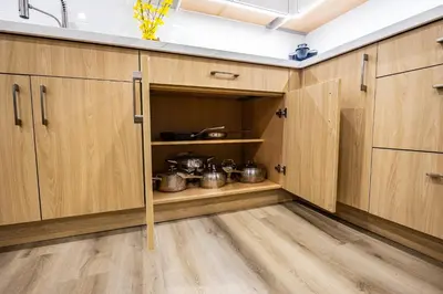 a kitchen with wooden cabinets with pots and pans at Charming Streetsville 2 Bedroom Suite with Parking and Laundry in Mississauga