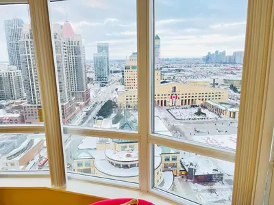 a view of a city from a window at 2 Bedroom Luxury Suite Across Square One in Mississauga