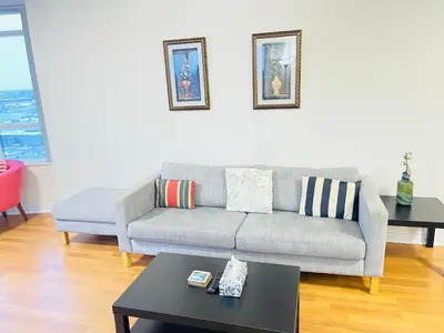 a living room with a couch and a table at 2 Bedroom Luxury Suite Across Square One in Mississauga