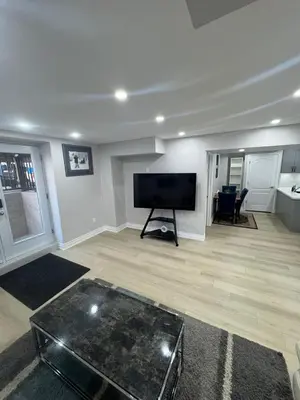 a large living room with a flat screen tv at Blessed Home in Milton