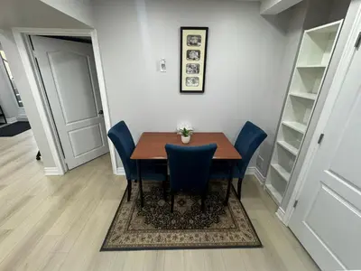 a dining room with a table and blue chairs at Blessed Home in Milton