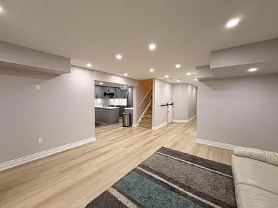 an empty living room with a couch and a kitchen at Blessed Home in Milton